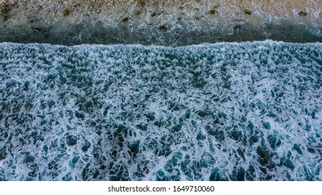 Ariel View Of Wave Crushing On A Rocky Beach