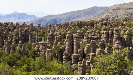 Arizona's Chiricahua National Monument rocky formations with mountains behind them, near Wilcox, in Cochise County, USA, not far from the border with Mexico.