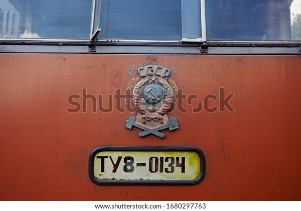 Arkhangelsk region, Russia - August 2017:  The coat\
of arms of the USSR on the train car and the inscription of a\
diesel locomotive\
model