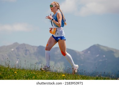 Arkhyz, Russia - July 3, 2022: Female Athlete Running Uphill Trail In Arkhyz X Run