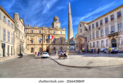 Arles, France - October 3, 2019: People walk on the town square in front of the city hall in Arles, France on October 3, 2019