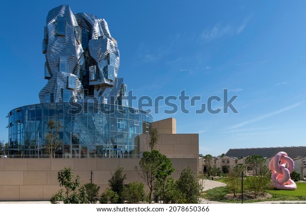Arles, France-October 2021; View of Luma\
Arles art center with tower of glass and stainless steel panels and\
building designed by architect Frank\
Gehry