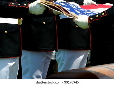 Arlington National Cemetery With Military Honor Guard Folding Flag Above Casket