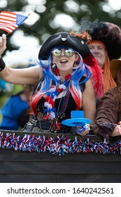Arlington, Texas, USA - July 4, 2019: Arlington 4th of July Parade, Float in shape of a Pirate ship, with people dress as pirates, waving American flags