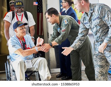 Arlington, VA, USA - September 21, 2019: WWII veterans arriving off an American Airlines honor flight at Ronald Reagan National Airport. They are greeted at the gate by military personnel 