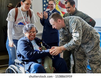 Arlington, VA, USA - September 21, 2019: WWII veterans arriving off an American Airlines honor flight at Ronald Reagan National Airport. They are greeted at the gate by military personnel 