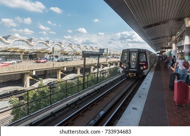 ARLINGTON, VIRGINIA - OCT. 12, 2017: Train arriving, Metro station Washington National Airport. Terminal background, Reagan National station with travelers, station served by Blue & Yellow line trains