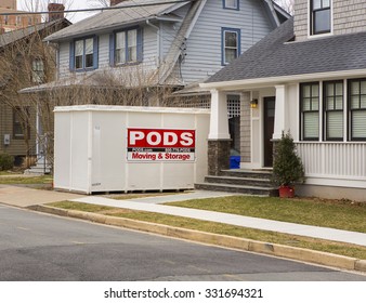 ARLINGTON, VIRGINIA, USA - MARCH 1, 2013: PODS storage container in front of houses.