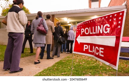 ARLINGTON, VIRGINIA, USA - NOVEMBER 4, 2008: Voting polling place sign and people lined up on presidential election day.