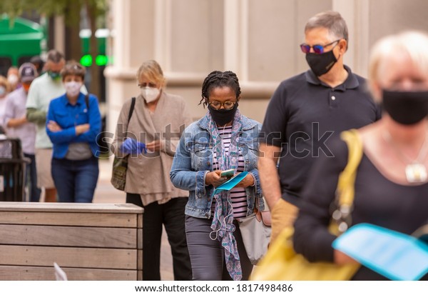 ARLINGTON,\
VIRGINIA, USA - SEPTEMBER 18, 2020: People line up during first day\
of early voting, 2020 presidential\
election.