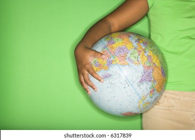 Arm Of African American Girl Holding Globe At Hip.