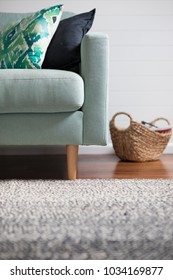 Arm Chair With Cushion Within A Hamptons Style House With Rug, Lit With Natural Light