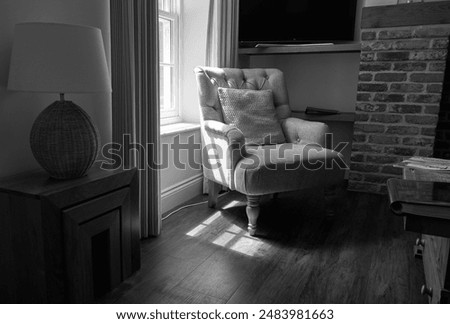 Arm chair next to a window                              