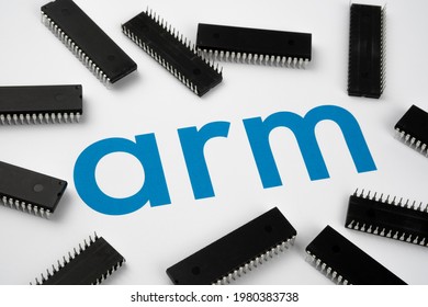 ARM Company Logo On The Paper Document And Large Microchips Placed Around. Illustrative For Electronic Chip Manufacturer.  ARM SOFTBANK NVIDIA Deal. Stafford, United Kingdom - May 25, 2021.