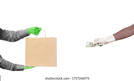 arm delivery man hold in hands brown craft paper package and black skin hand holds give money to pay for food delivery isolated on white, safe online buying social distancing, stay home.