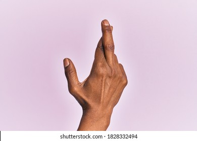 Arm And Hand Of Black Middle Age Woman Over Pink Isolated Background Gesturing Fingers Crossed, Superstition And Lucky Gesture, Lucky And Hope Expression 