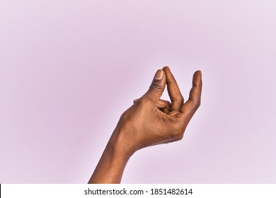 Arm and hand of black middle age woman over pink isolated background snapping fingers for success, easy and click symbol gesture with hand 