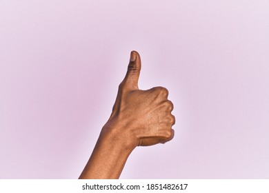 Arm And Hand Of Black Middle Age Woman Over Pink Isolated Background Doing Successful Approval Gesture With Thumbs Up, Validation And Positive Symbol 