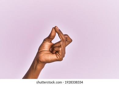 Arm And Hand Of Black Middle Age Woman Over Pink Isolated Background Snapping Fingers For Success, Easy And Click Symbol Gesture With Hand 