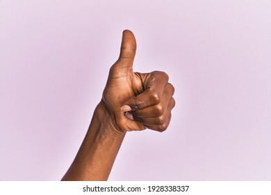 Arm And Hand Of Black Middle Age Woman Over Pink Isolated Background Doing Successful Approval Gesture With Thumbs Up, Validation And Positive Symbol 