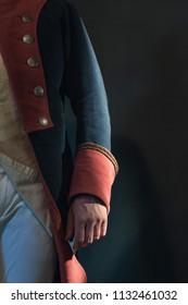 Arm of historical regency man in uniform.