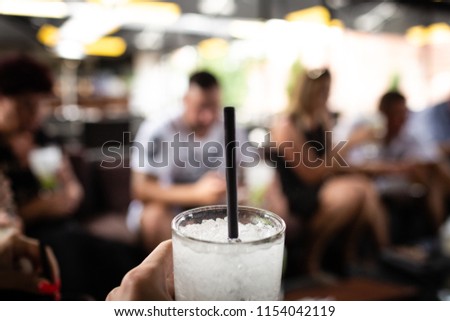 Similar – Woman holding lemonade glass and friends cooking in barbecue