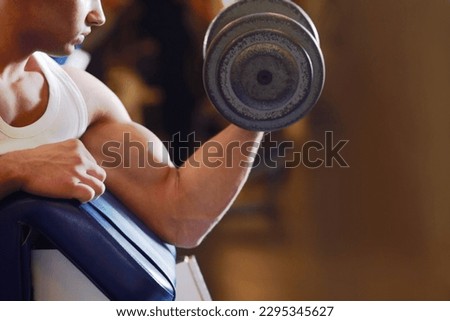 Arm strength, dumbbell and man with training routine, athlete determination or focus on power, health or club challenge. Determined, healthy fitness and ripped person workout for strong bicep growth