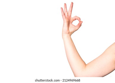 An Arm Of A Woman Doing The Number Zero Hand Gesture. Female Hand Doing The Ok Symbol On White Background.