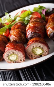 Armadillo Eggs Are A Classic Texas BBQ Staple Served With Salad Close Up On A Plate On The Table. Vertical
