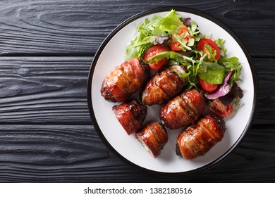 Armadillo Eggs Are A Classic Texas BBQ Staple Served With Salad Close Up On A Plate On The Table. Horizontal Top View From Above
