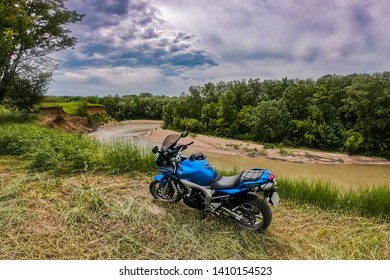 Armavir, Krasnodarsky Kray / Russia -  May 26 2019: Yamaha Motorcycle Stands On A Cliff On The Background Of A Mountain River And Clouds.