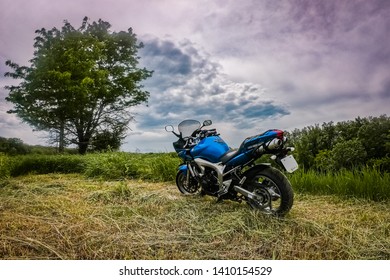 Armavir, Krasnodarsky Kray / Russia -  May 26 2019: Yamaha Motorcycle Stands On A Cliff On The Background Of A Mountain River And Clouds.