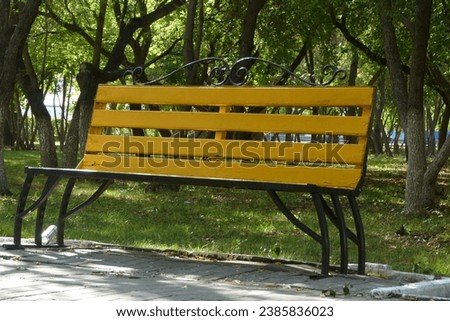 armchair backyard bench chair furniture day to rest road seat yellow object park close-up foliage green landscaped