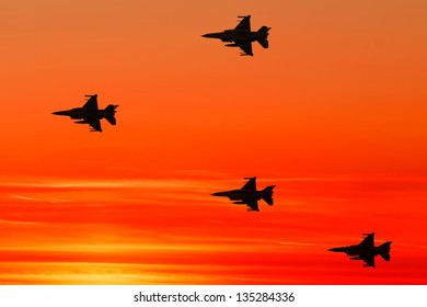 Armed Fighter Jets On The Red Sunset Background