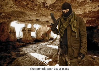armed masked soldier in a cave. guerrilla warfare concept.