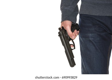 Armed Person Holding Handgun Wearing Dark Blue Jeans And Hoodie Isolated On White Background, Copy Space, Close-up On Gun