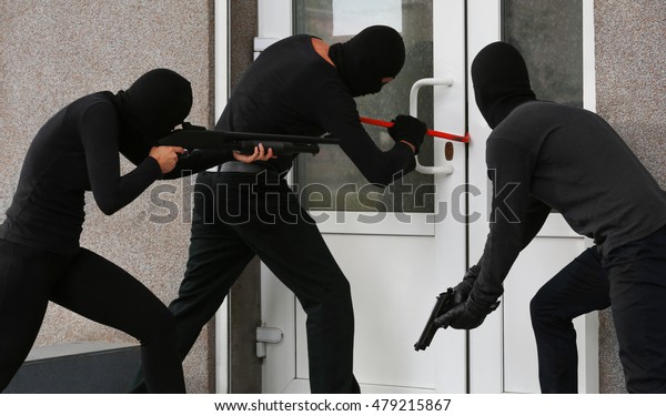 Armed thieves breaking a
door