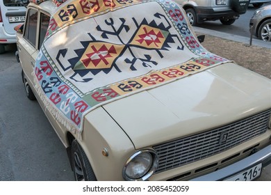 Armenia, Yerevan, September 2021. A Vintage Car Covered With An Old Carpet.