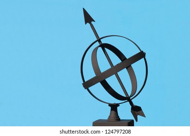 Armillary Sphere silhouetted against a blue background