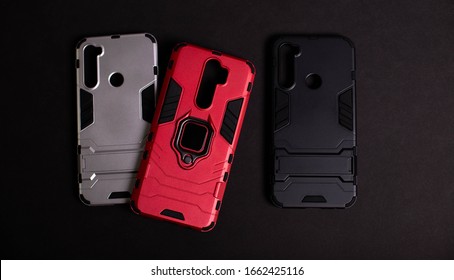 Armor Case For Phone. Strong Plastic Case To Protect Your Phone. Plastic Cases On Black Background.