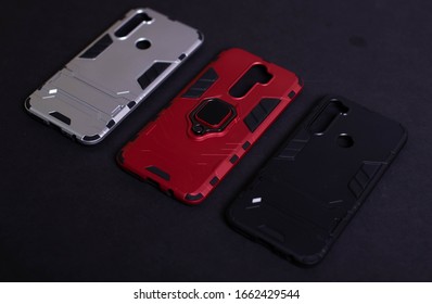 Armor Case For Phone. Strong Plastic Case To Protect Your Phone. Plastic Cases On Black Background.