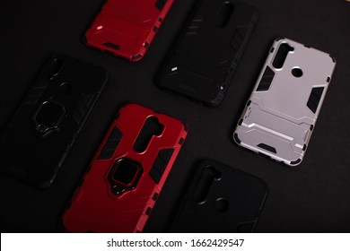 Armor Case For Phone. Strong Plastic Case To Protect Your Phone. Plastic Cases On Black Background.