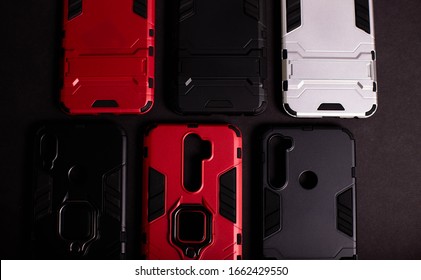 Armor Case For Phone. Strong Plastic Case To Protect Your Phone. Plastic Cases On Black Background.