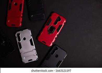 Armor Case For Phone. Strong Plastic Case To Protect Your Phone. Plastic Cases On Black Background.