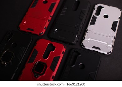 Armor Case For Phone. Strong Plastic Case To Protect Your Phone. Plastic Cases On Black Background.