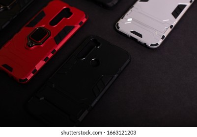 Armor Case For Phone. Strong Plastic Case To Protect Your Phone. Plastic Cases On Black Background.