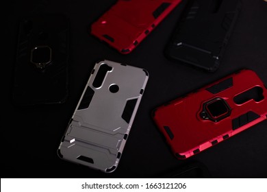 Armor Case For Phone. Strong Plastic Case To Protect Your Phone. Plastic Cases On Black Background.