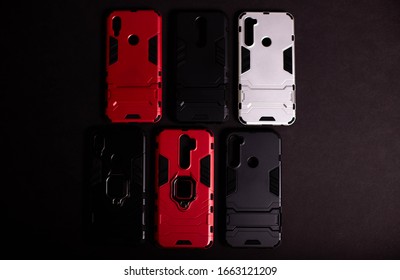 Armor Case For Phone. Strong Plastic Case To Protect Your Phone. Plastic Cases On Black Background.