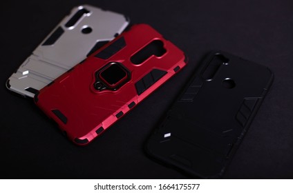 Armor Case For Phone. Strong Plastic Case To Protect Your Phone. Plastic Cases On Black Background.