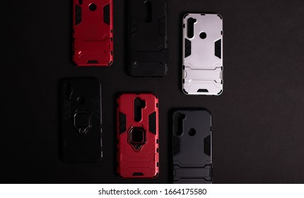 Armor Case For Phone. Strong Plastic Case To Protect Your Phone. Plastic Cases On Black Background.